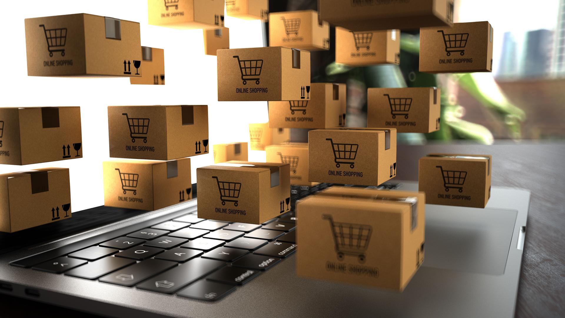 Small shipping packages on a notebook with the inscription Online Shopping